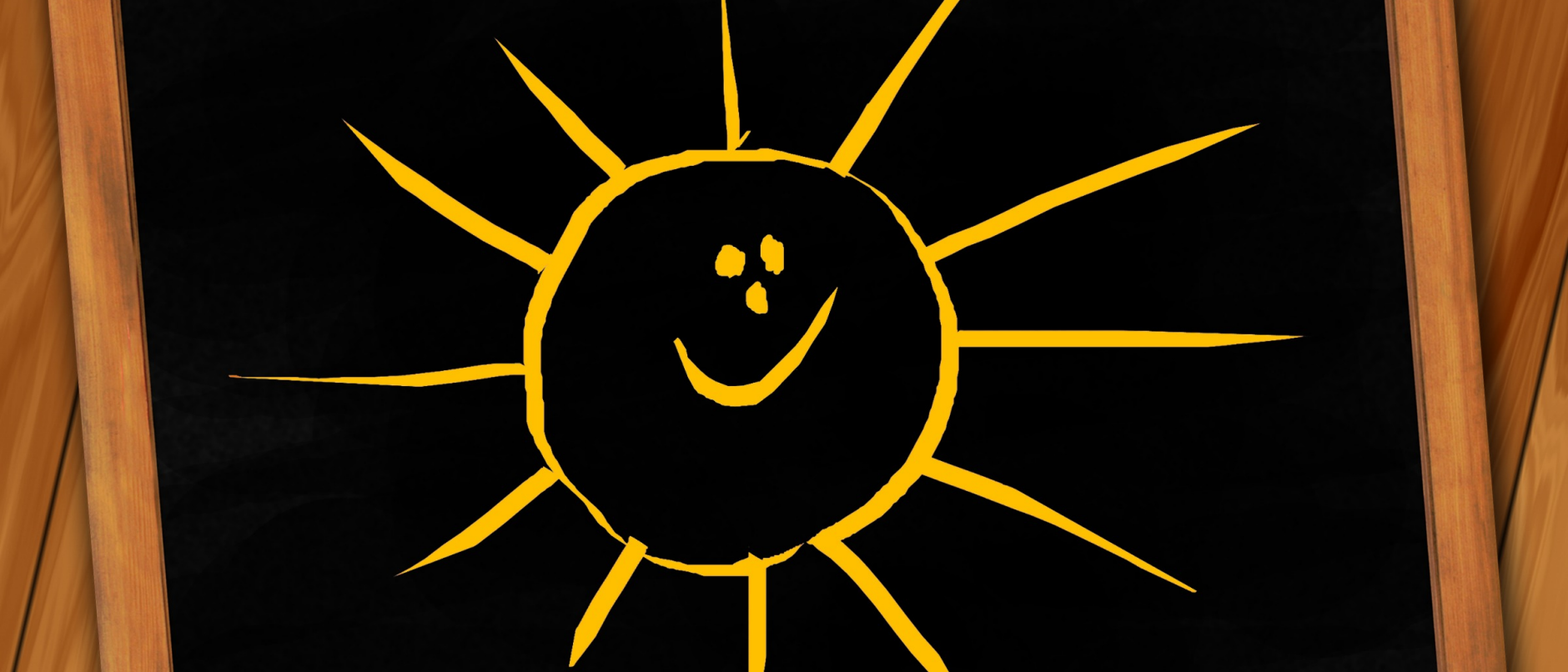 Bild på en svart tavla med en gul sol
